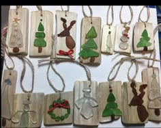 christmas ornaments are hanging on wooden boards with string attached to the strings, and decorated with glass ornaments