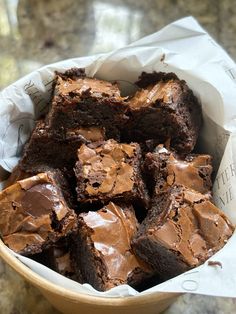 a bowl filled with brownies on top of a table