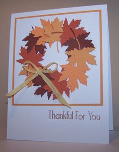 a thank you card with an orange and brown leaf wreath on it's front