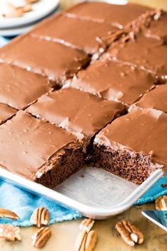 there is a chocolate cake that has been cut in half and ready to be eaten