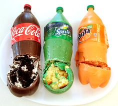 three bottles of soda and some cake on a plate