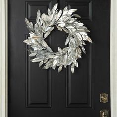 a black door with a wreath on it