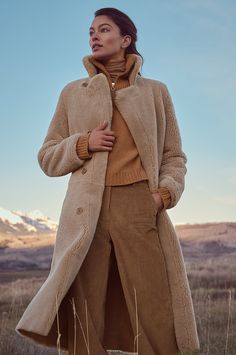 For the ultimate in warmth and timeless grace, cozy up to winter in the Isabella full-length sheepskin coat. Crafted from soft, genuine curly sheepskin, this gorgeous coat features a smooth sueded side with plush trim for a more elegant, dramatic look and an all-plush reverse side for when you want to embody a more rustic-casual style. Either way you wear it, the versatile Isabella features a notch collar, corozo button closures, and two slip pockets. Reversible Coat, Sheepskin Slippers, Sheepskin Coat, Dramatic Look, Coat Fashion, Winter Wear, Leather Coat, Crochet Clothes, Casual Style