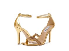 Steve Madden Confeti Heeled Sandal - Women's Shoes : Gold : Get ready to jazz up your outfit wearing the super-sleek and chic Steve Madden Confeti Heeled Sandals. Synthetic upper with intertwined jewel-encrusted toe straps. Synthetic lining and insole. Adjustable buckle closure on the ankle strap. Square open toe. High stiletto heel. Metallic detailing. Synthetic outsole. Imported. Measurements: Heel Height: 4 in. Glamorous Gold Sandals With Adjustable Fit, Adjustable Evening Sandals, Glamorous Spring Sandals With Chain Strap, Adjustable Glamorous Gold Sandals, Glamorous Adjustable Gold Sandals, Gold Strap Sandals For Evening, Gold Strappy Heels For Party, Gold Strap Heels For Party, Gold Heels With Strap For Party