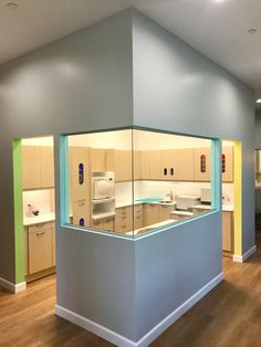 an empty kitchen and dining area in a building with hard wood flooring on the wooden floors