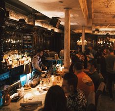 a group of people sitting around a bar