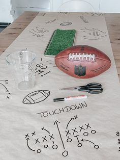 a table topped with footballs and other sports related items