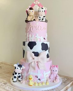 a three tiered cake decorated with farm animals