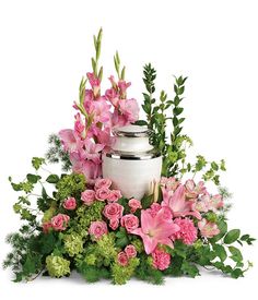 an arrangement of pink flowers and greenery