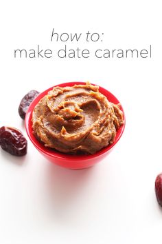 a red bowl filled with peanut butter next to raisins on a white surface