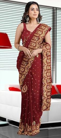 Red and Maroon color Saree in Georgette fabric with Stone work Red Floor-length Saree For Traditional Ceremonies, Elegant Red Embroidered Fabric For Wedding, Elegant Red Embroidered Fabric For Reception, Red Saree For Reception And Festivals, Burgundy Saree With Zari Work For Wedding, Burgundy Wedding Saree With Zari Work, Festive Burgundy Saree With Zari Work, Red Georgette Embroidered Fabric For Designer Wear, Traditional Burgundy Wedding Wear