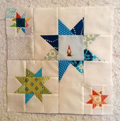 a close up of a patchwork quilt with stars on it