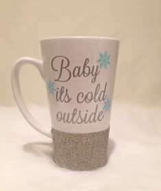 a coffee cup that has some glitter on it and the words baby its cold outside