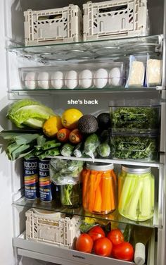 an open refrigerator filled with lots of fresh vegetables and fruits in it's shelves