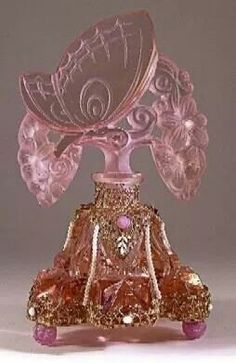 a pink glass vase sitting on top of a table