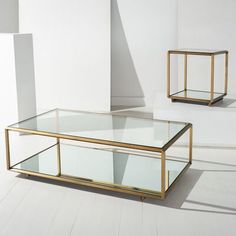 two glass tables sitting next to each other on top of a white floor covered in light