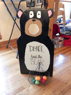 a cardboard bear with a sign that says don't seed the bear on it