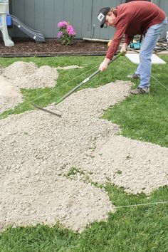 a man using a lawn mower to cut grass