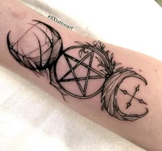 a black and white photo of a tattoo on the arm with an inverted pentagramil