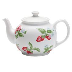 a teapot with strawberries on it and green leaves painted on the outside, in white