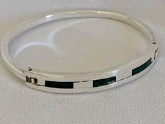 "Beautiful artisan craftsmanship in the hinged sterling silver bracelet with inlay malachite pieces. It's the type of bracelet you would expect to see made in Mexico. Absolutely lovely. In very good vintage condition. The oval bracelet is hinged. Marked: 925 Mexico TA-6? The makers mark is not well stamped Inside dimensions: 2-1/4\" x 2\" Width: 7.4 mm to 2.7 mm Weight: 19.6 grams Your purchase supports the missions and ministries of St Paul's United Methodist Church." Oval Bracelet, Not Well, Malachite Bracelet, Oyster Bay, United Methodist Church, Methodist Church, Sterling Silver Bracelet, Makers Mark, Sterling Silver Bracelets