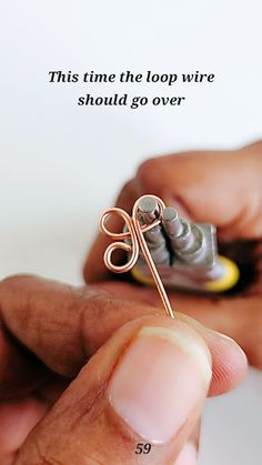 a person is holding a small wire with scissors in their hand and the text reads, this time the loop wire should go over