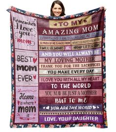 a woman holding up a blanket with the words to my amazing mom on it in different languages