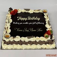 a birthday cake with white frosting and strawberries on it