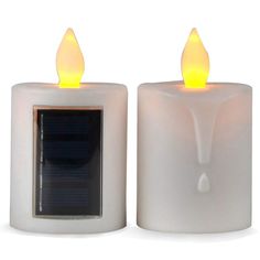 two white candles with yellow lights on each one and a solar panel in the middle