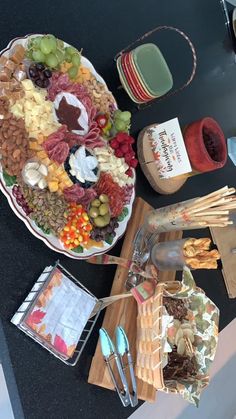 a large platter of meats, cheeses and crackers on a table