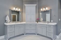 a large bathroom with two sinks and mirrors