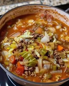 a large pot filled with soup on top of a stove