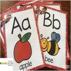 three children's books with pictures of apples and bees on them, sitting on a table