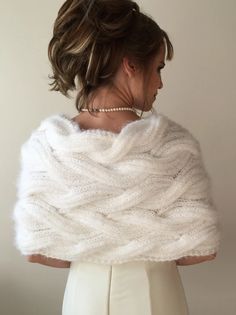 a woman wearing a white knitted shawl