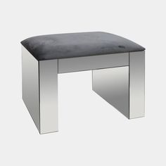 a silver bench with a black cushion on it's top and bottom part in the shape of a rectangle