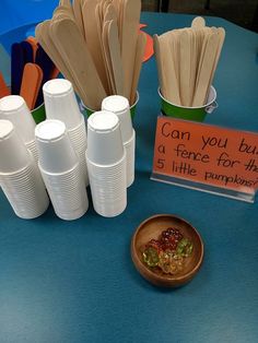 there are many cups and spoons on the table with signs in front of them that say can you buy a piece for the 5 little pumpkin?