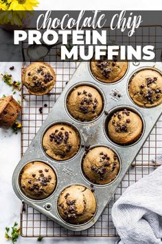 chocolate chip protein muffins in a muffin tin on a cooling rack with flowers