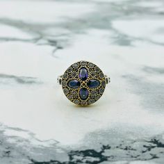 This piece is a quaint and chic 70's bohemian vintage jewelry style and has a certain sense of nostalgia to your fashion, it is the perfect casual and special event ting. The ring exhibits a beautiful anemone flower pattern, with four petals of amethyst stones mounted on a background of detailed with intricate oxidized , giving the illusion of depth and contrast to the design. To look aged, it has been subject to a method that adds patina, giving it a vintage look, which instantly makes it a pre Bohemian Multi-stone Ring, Bohemian Multi-stone Rings For Gifts, Bohemian Silver Amethyst Ring, Gold Bohemian Multi-stone Rings, Bohemian Gold Multi-stone Rings, Bohemian Oval Multi-stone Rings, Vintage Gold Flower Ring In Sterling Silver, Bohemian Amethyst Ring As Gift, Bohemian Flower Ring With Gemstone