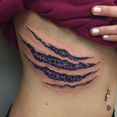 a woman's stomach with an animal print tattoo on her lower back and side