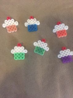 six legos are arranged in the shape of sheeps and rainbow - colored circles