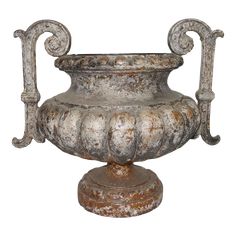 an old metal urn sitting on top of a white background