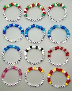 six bracelets with different colors and designs on each one, all made out of plastic beads