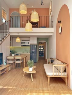 a living room filled with furniture next to a wooden floor and staircase leading up to a second story