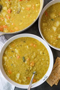 three bowls filled with soup next to crackers