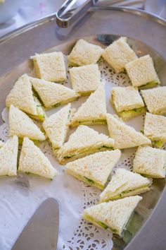 there are many sandwiches cut in half on the plate and ready to be put into the oven