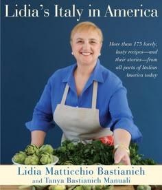 a woman in an apron standing behind a table with vegetables on it and the title lidia's italy in america