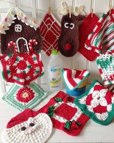 several crocheted christmas items are displayed on a white table with green and red decorations