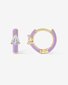 These colored enamel huggie earrings are the perfect accessory to elevate both day and evening looks. Whether you're going for trendy sophistication or a subtle hint of glam, these earrings have got you covered.Materials: 14K yellow or white gold plated. 925 sterling silver posts. AAAAA Cubic Zirconia. Blue, Pink, Purple or White Enamel. Measurements: Diameter: 10.8mm (.42"); Thickness: 2mm. Stone size: 3x4 mm. Pink Enamel Jewelry, Enamel Bracelets, Elegant Enamel Pierced Earrings, Luxury Enamel Earrings, Trendy Enamel Huggie Earrings, Luxury Polished Enamel Earrings, Enamel Huggie Hoop Earrings, Enameling Jewelry, Dangle Necklaces