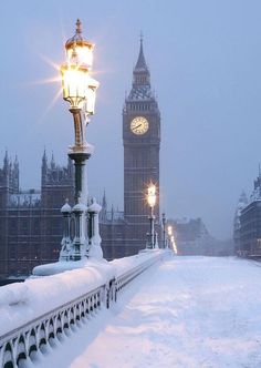 the big ben clock tower towering over the city of london covered in snow