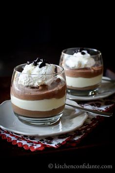 two desserts with chocolate and whipped cream on them